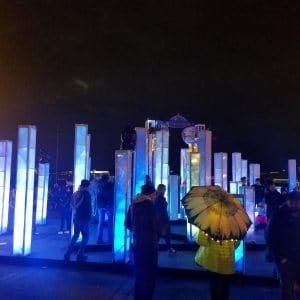 people in front of illuminated columns at night